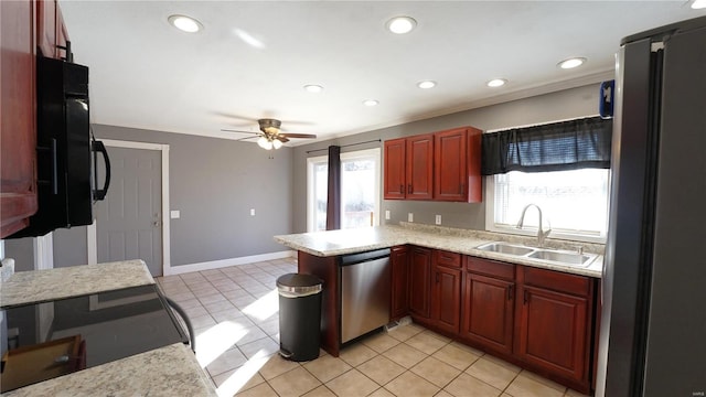 kitchen featuring reddish brown cabinets, appliances with stainless steel finishes, a peninsula, a sink, and recessed lighting