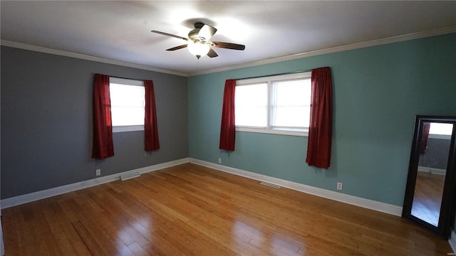 unfurnished room featuring hardwood / wood-style floors, plenty of natural light, and visible vents