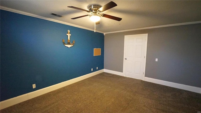 unfurnished room with baseboards, dark colored carpet, visible vents, and crown molding