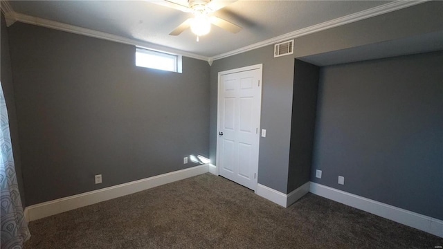 interior space with crown molding, ceiling fan, visible vents, and baseboards