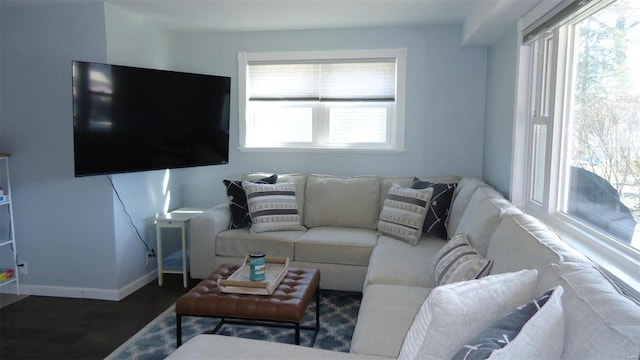 living area featuring baseboards and wood finished floors