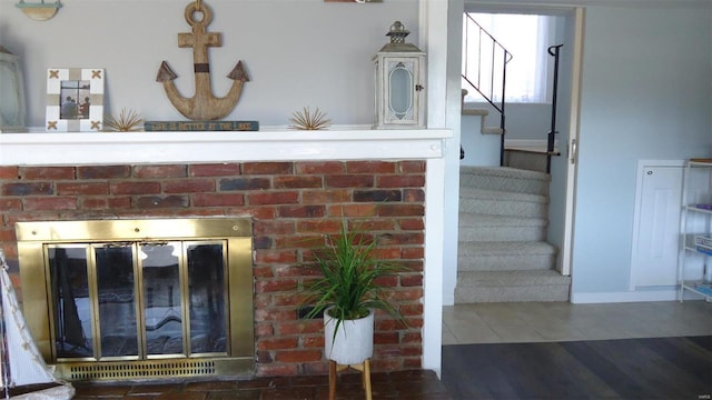 room details featuring a fireplace and wood finished floors