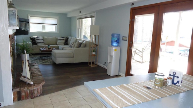 living room with tile patterned flooring and baseboards