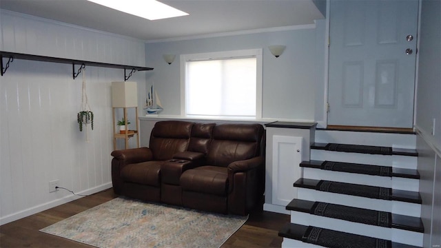 living room featuring a skylight, ornamental molding, and dark wood-style flooring