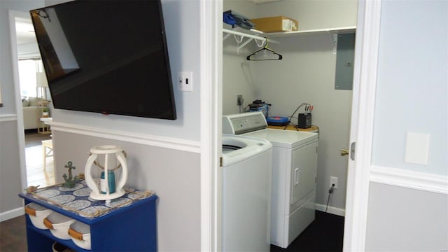 clothes washing area with laundry area, electric panel, independent washer and dryer, and baseboards