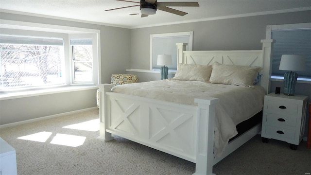 bedroom with carpet floors, ornamental molding, a ceiling fan, and baseboards