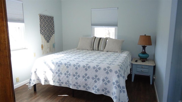 bedroom with wood finished floors and baseboards