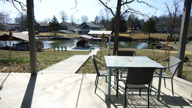 dock area featuring outdoor dining space, a patio area, and a water view