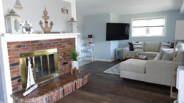 living area featuring a fireplace, baseboards, and wood finished floors