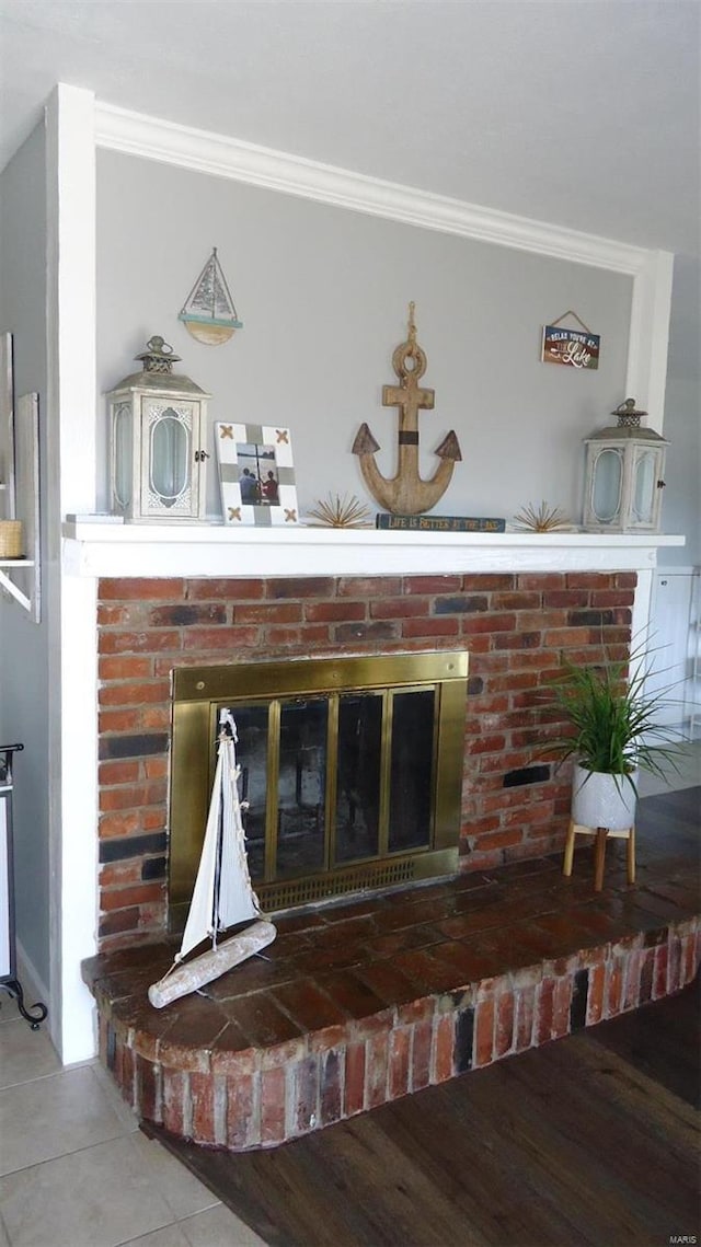 details with a fireplace, wood finished floors, and crown molding