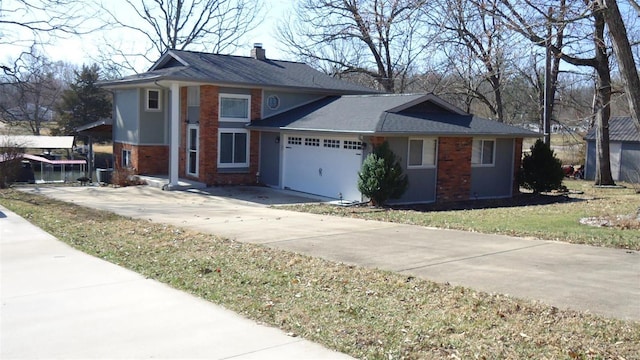 view of front facade with driveway, an attached garage, a chimney, and brick siding