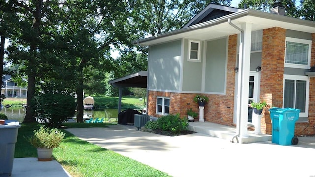 view of side of home with brick siding and a chimney