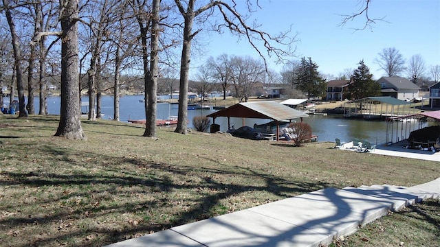 view of yard featuring a water view and a boat dock