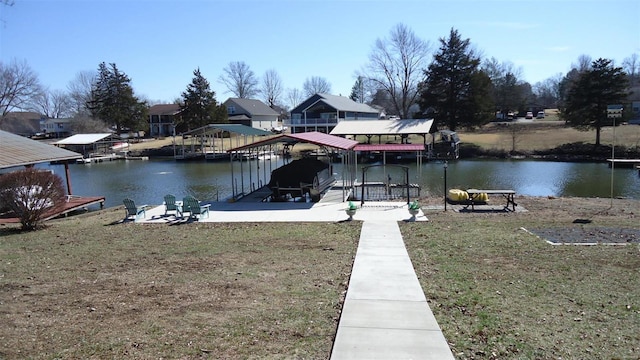 view of dock with a yard, a water view, and boat lift