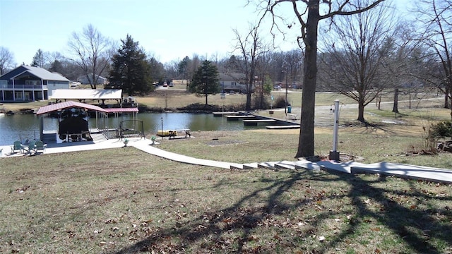 view of yard with a water view and a boat dock