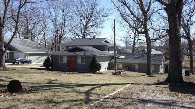 view of property exterior with a chimney and a yard