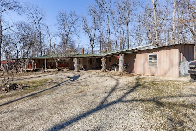 view of front of property with driveway and a chimney