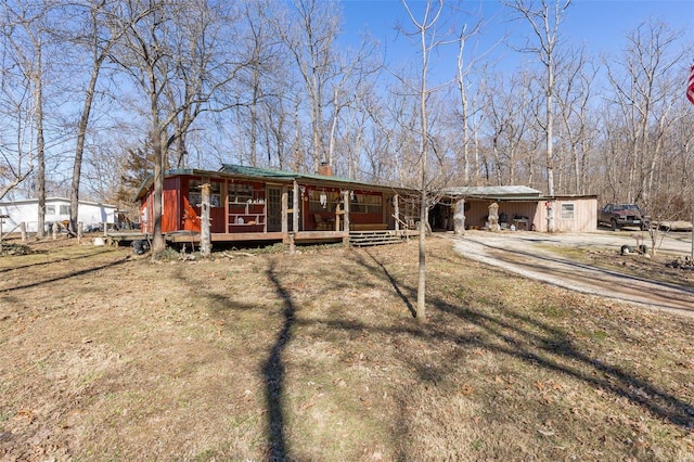 view of front of home featuring covered porch and a chimney