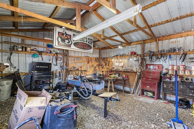 garage with a workshop area and metal wall