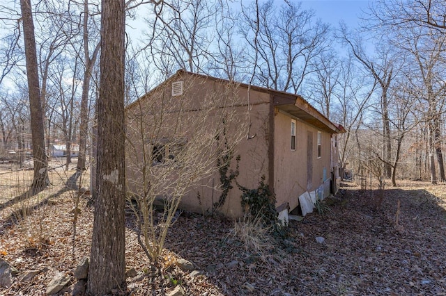 view of side of property featuring stucco siding