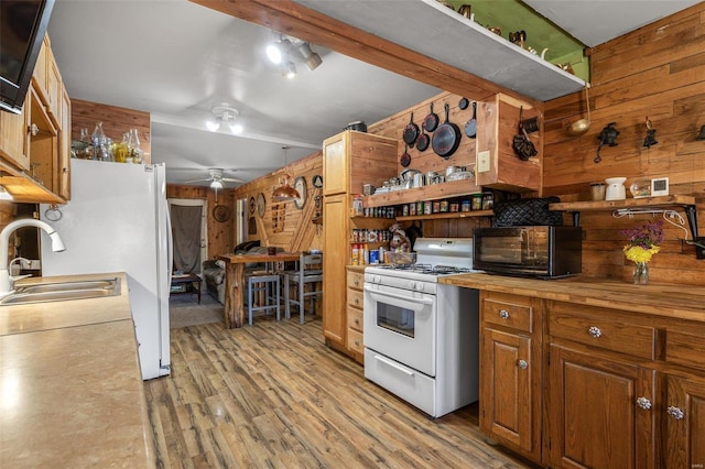 kitchen with white appliances, wooden counters, light wood finished floors, and open shelves