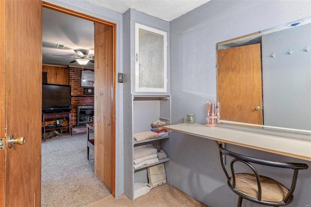 office with visible vents, carpet, and a ceiling fan