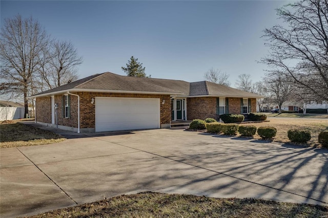 ranch-style house with an attached garage, concrete driveway, and brick siding