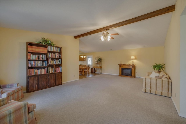 living area featuring vaulted ceiling with beams, a fireplace, a ceiling fan, carpet flooring, and baseboards