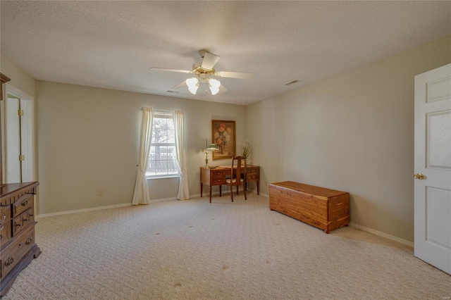 living area featuring baseboards, visible vents, a ceiling fan, a textured ceiling, and carpet floors