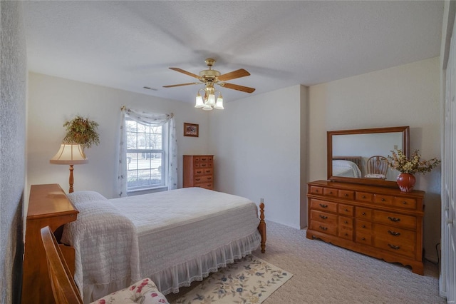 bedroom featuring a ceiling fan and carpet