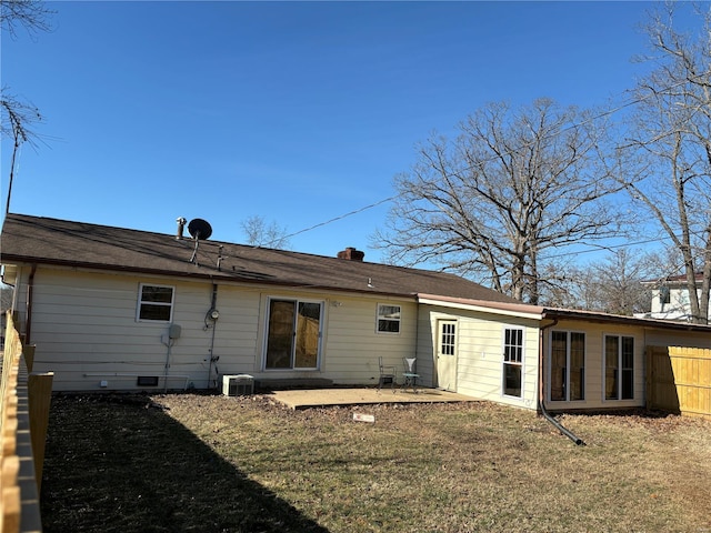 rear view of property featuring central air condition unit, fence, crawl space, a lawn, and a patio area