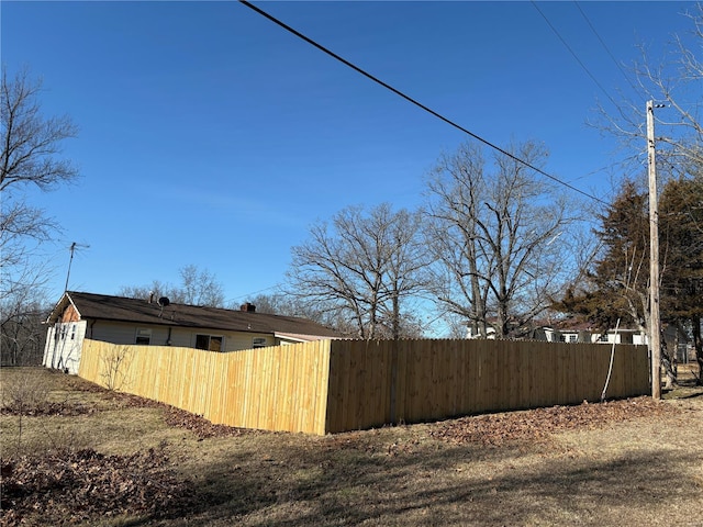 view of side of property with a chimney and fence