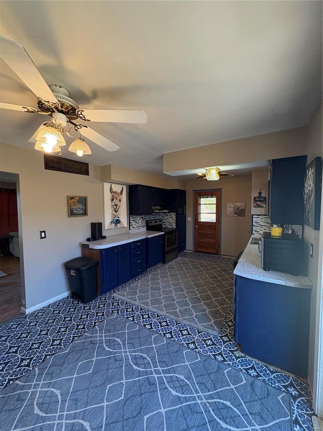 kitchen with stainless steel electric stove, light countertops, ceiling fan, blue cabinets, and baseboards