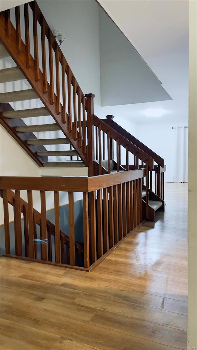 stairs featuring wood finished floors