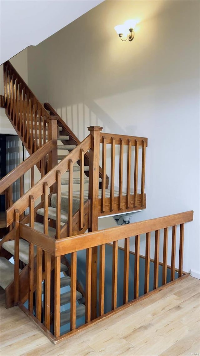 stairway with wood finished floors