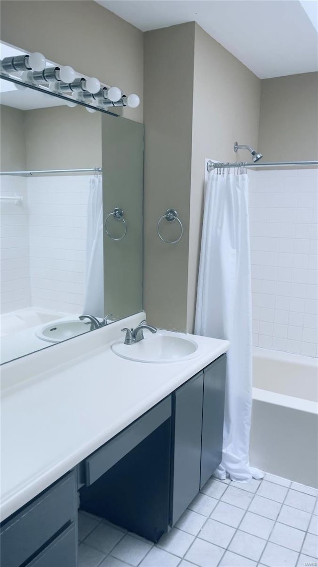 bathroom with tile patterned flooring, vanity, and shower / tub combo