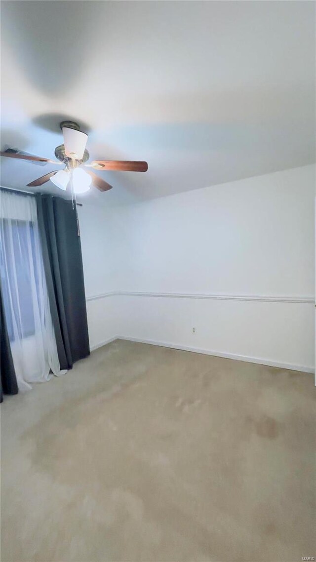 unfurnished room with light colored carpet and baseboards