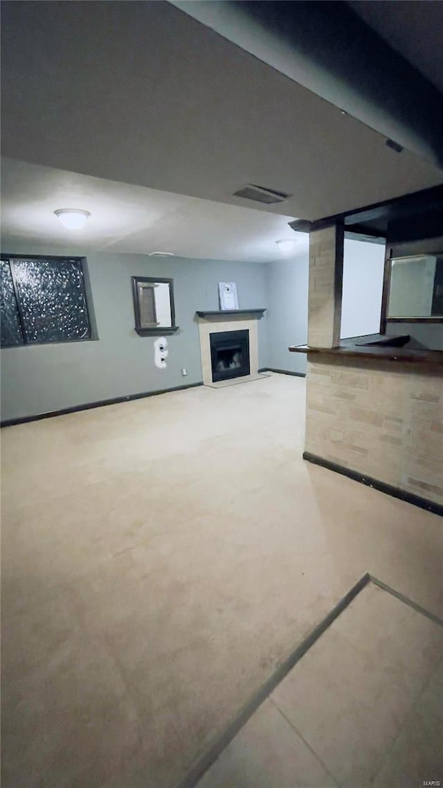 basement featuring visible vents and a fireplace