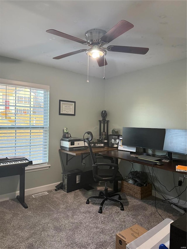 office space featuring carpet flooring, visible vents, and baseboards