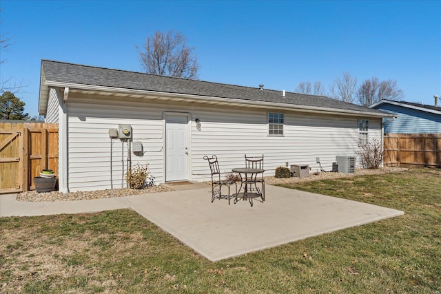 back of house with a yard, central air condition unit, a patio, and fence