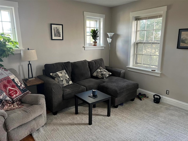 living area featuring a wealth of natural light and baseboards