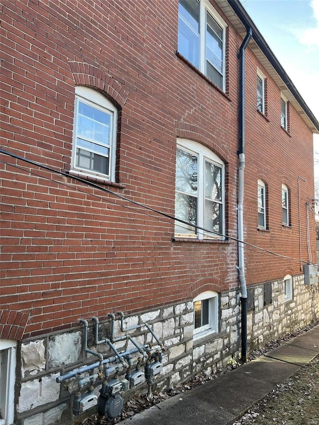 view of side of home featuring brick siding