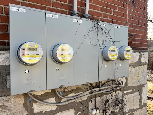 details featuring brick siding and electric meter