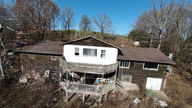 rear view of property with an attached garage