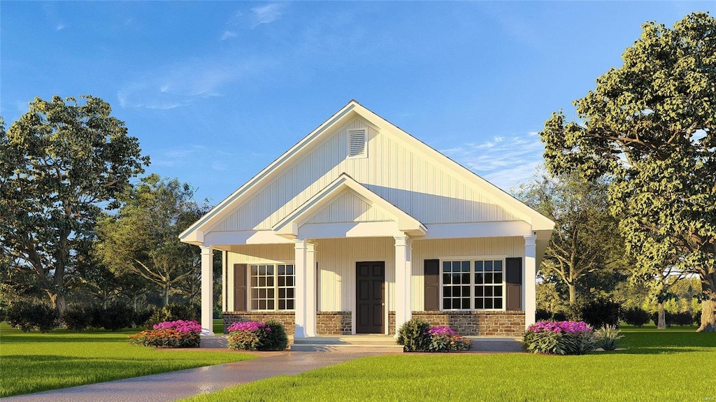 view of front of property with board and batten siding and a front yard