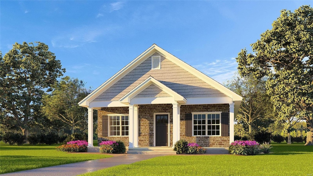 view of front of property featuring stone siding, brick siding, and a front yard