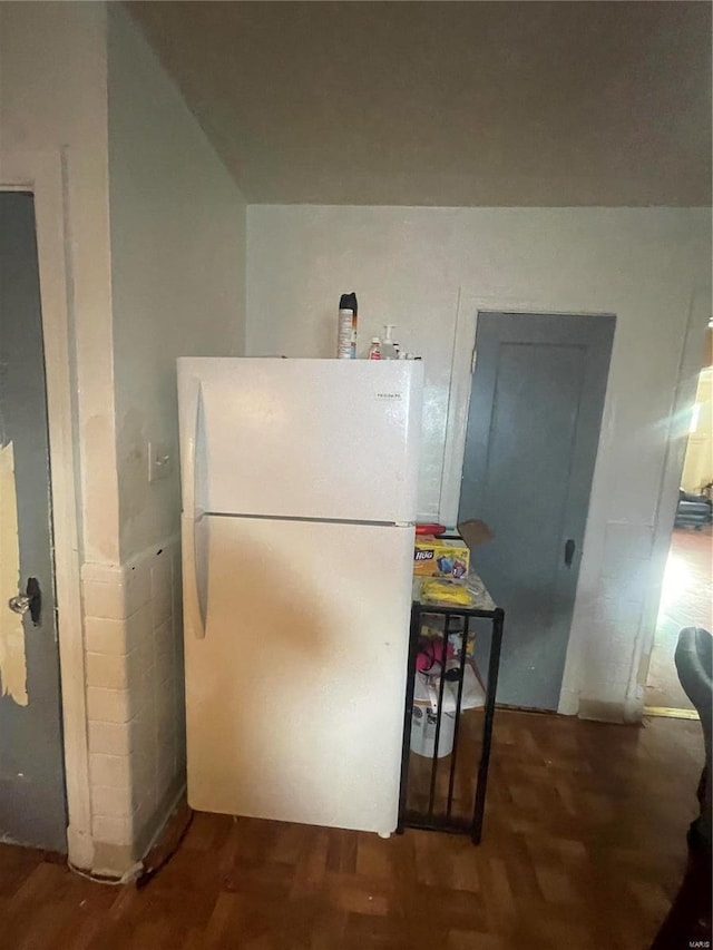 kitchen featuring wood finished floors and freestanding refrigerator