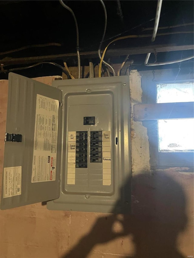 utility room featuring a garage and electric panel