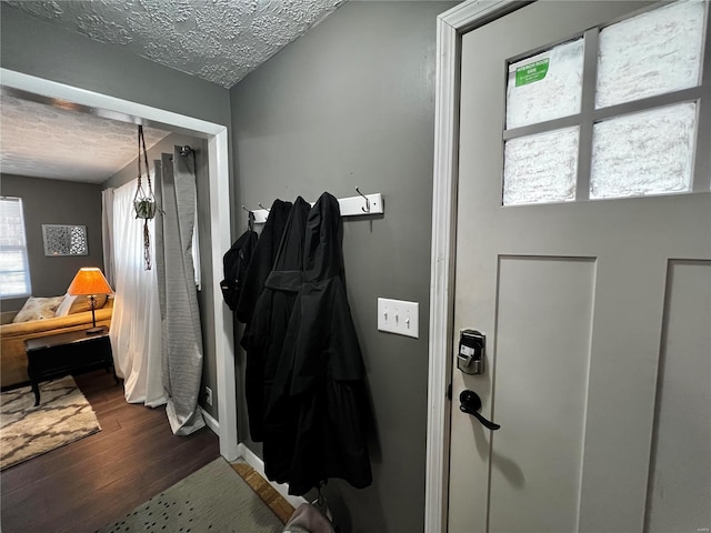 entryway with a textured ceiling and wood finished floors