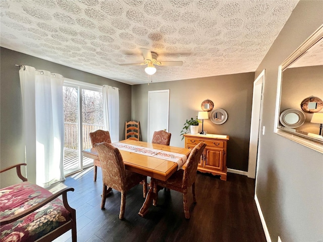 dining space with dark wood finished floors, a textured ceiling, baseboards, and ceiling fan